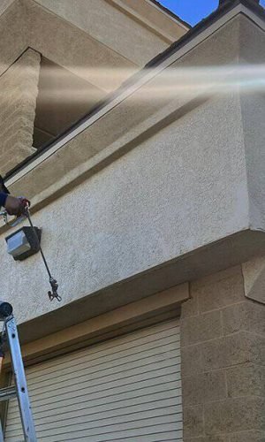 Professional pressure washing of a house exterior in California for curb appeal and property mainten.