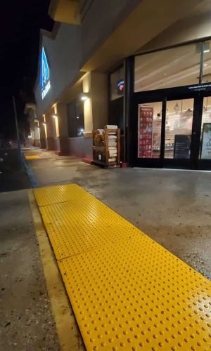 Commercial storefront exterior cleaned with pressure washing in California at night.