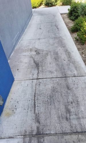 Freshly pressure-washed concrete sidewalk in California with clean, bright surface.