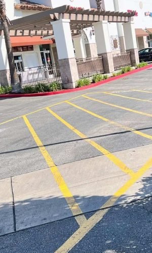 Pressure washing of commercial parking lot in California.