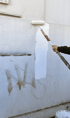 Professional pressure washing of exterior wall to remove dirt and grime.
