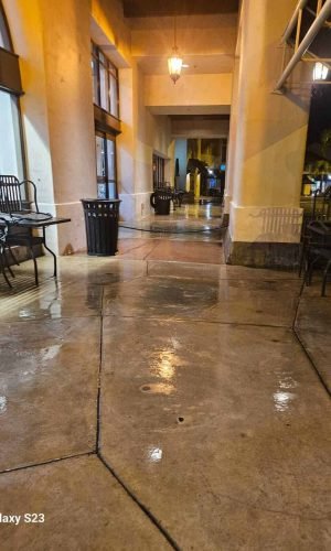 Commercial building entrance after pressure washing, showcasing clean and shiny concrete floors at n.