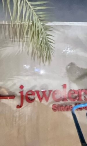 Pressure washing of a commercial wall with Daniel's Jewelers logo.