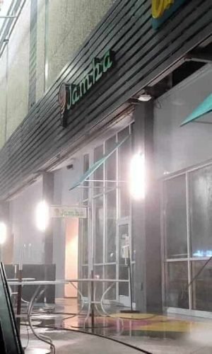 Pressure washing storefront exterior for deep cleaning and stain removal.